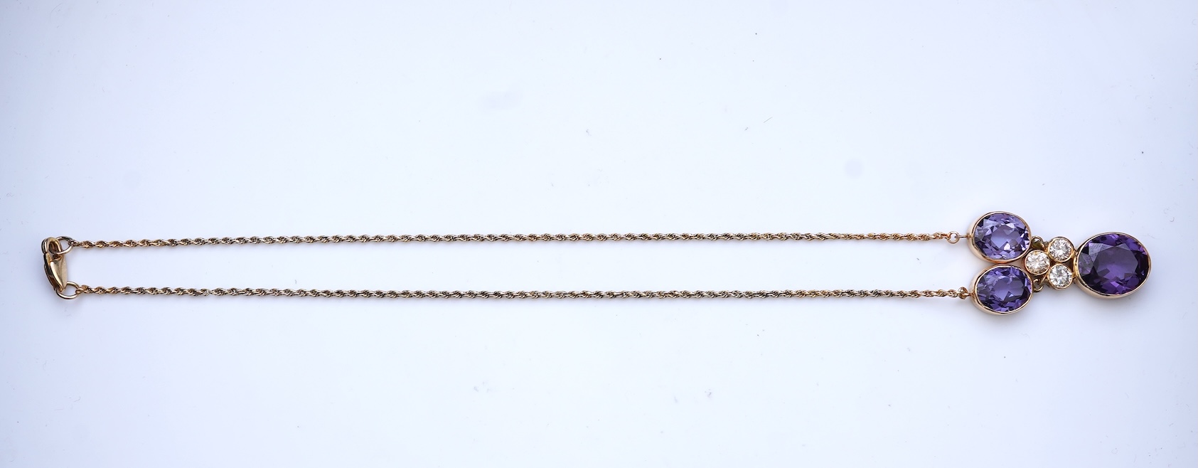 A synthetic colour-change sapphire and diamond pendant necklace